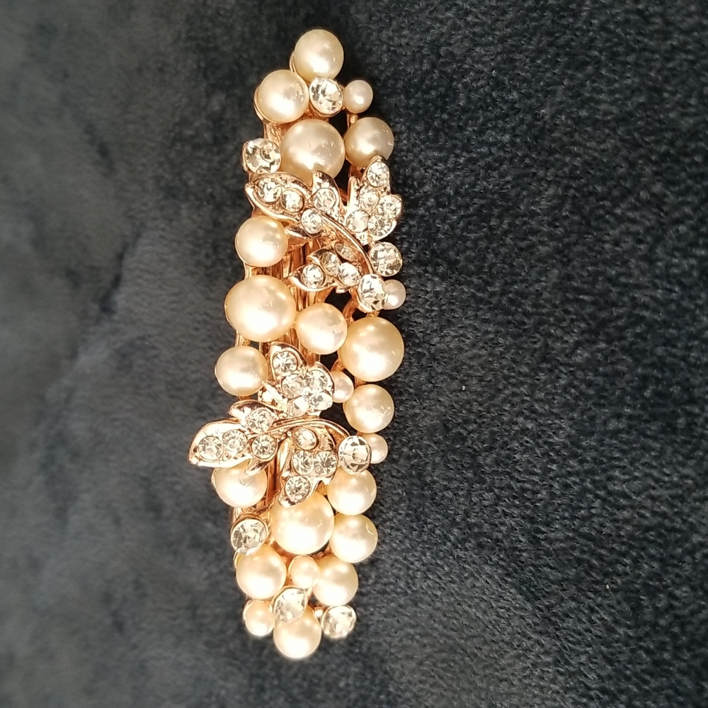 Hair accessory.  Has 2 leaves with crystals and pearls.